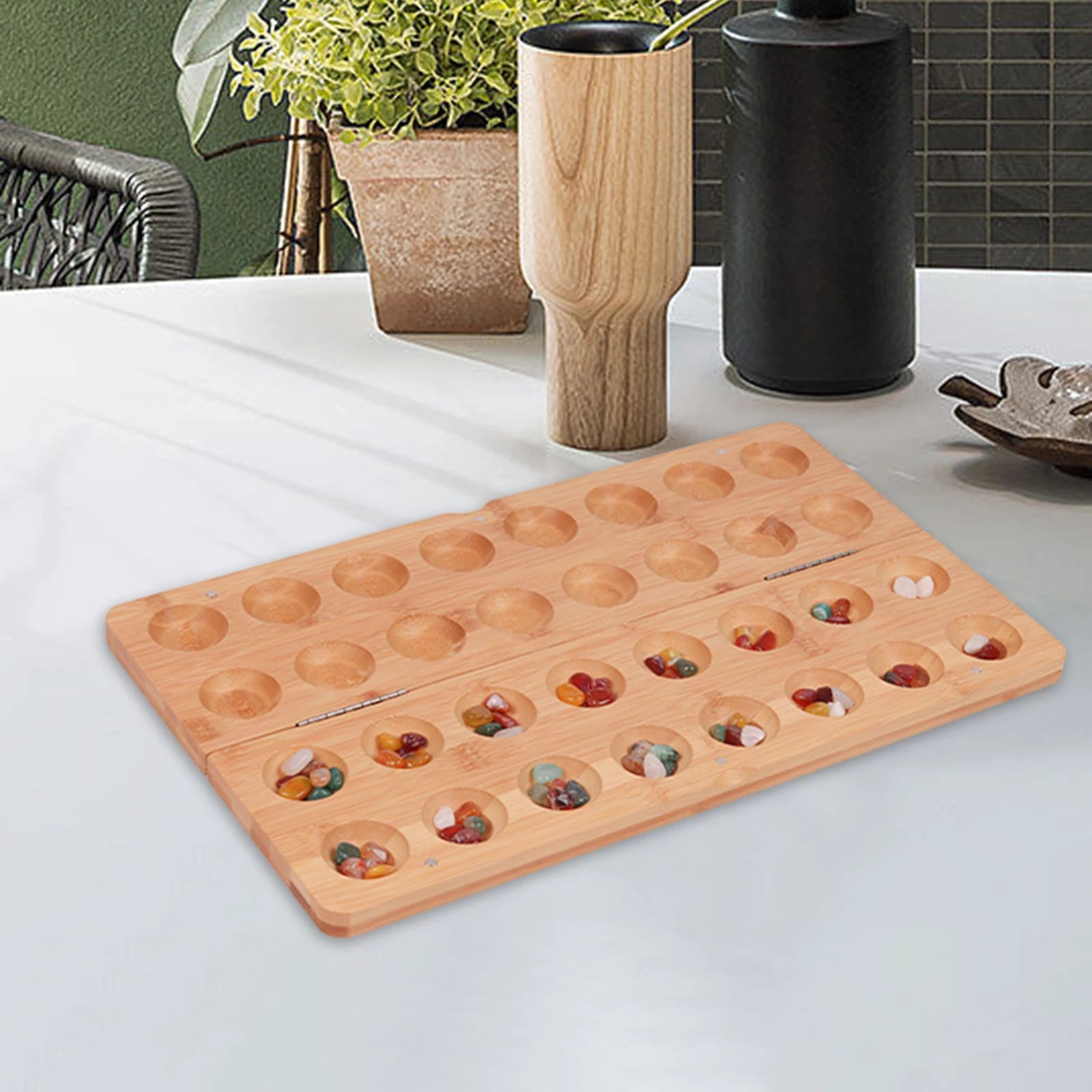 Classic mancala board game with colored stones timeless strategy for friends and family folding