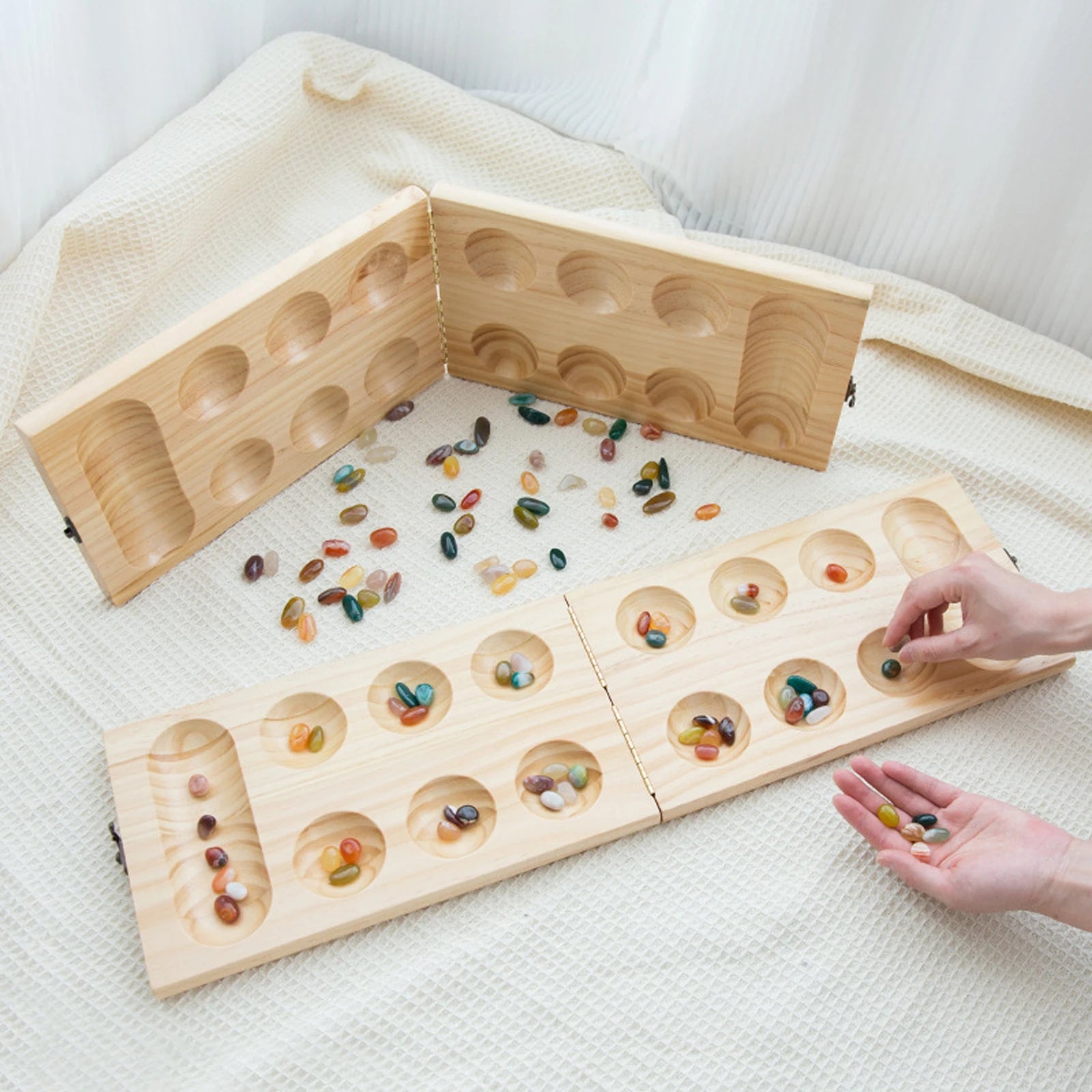 Classic mancala board game with colored stones timeless strategy for friends and family folding