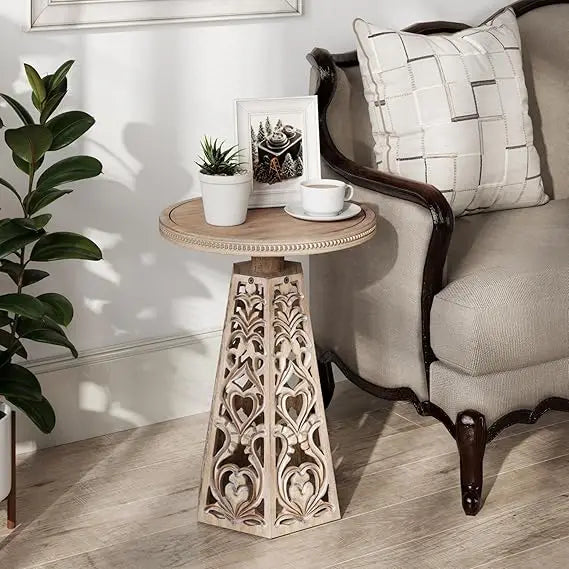 Vintage-style round wooden side table with detailed carved flowers suitable for bohemian living room decor - distressed